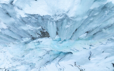 Waterfall that has turned to ice in the mountain. Drone photo from Norway.