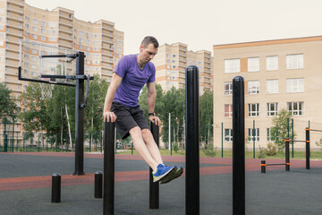 Man performing dips on workout pillars