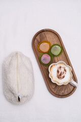  Cup of coffee, colourful mochi on wooden tray. Time for relaxing.