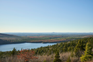 Beautiful, almost unreal view overlooking miles of Maine forest and countryside in the fall. The autumn colors are colorful. Eagle lake is toward the bottom of Cadillac mountain