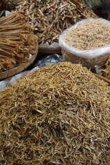 Closeup shot of mixed dried fish in a seafood market, Salted dried fish being sold at an Asian fish market, Freshly caught dried sea fish at a local market
