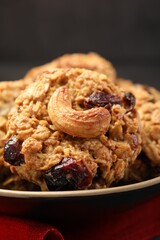 Delicious oatmeal cookies with raisins and nuts on table, closeup