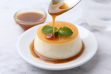 Tasty pudding with caramel sauce served on white marble table, closeup