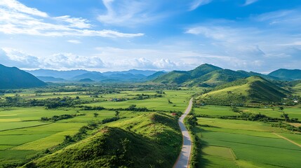 Obraz premium Scenic Road Winding Through Lush Green Valley and Mountains
