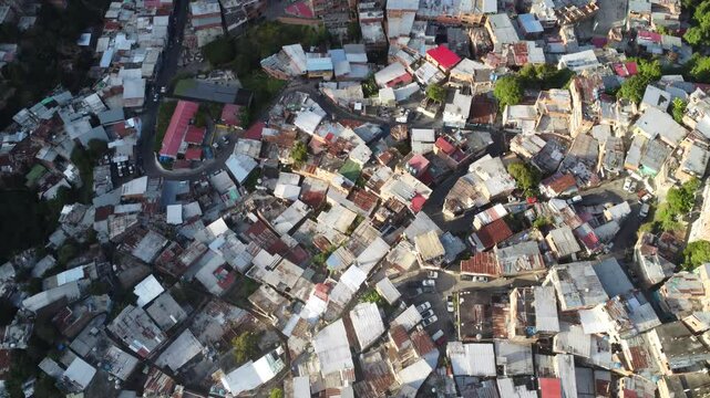 Aerial view of Caracas favelas, Venezuela &ndash; Dense hillside neighborhoods with colorful homes, urban sprawl, and vibrant local culture under a mountainous backdrop