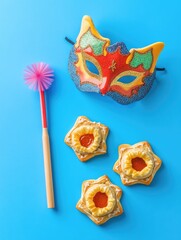 Blue background with a red and white mask and a pink brush. The brush is pink and has a fluffy bristle. The mask is red and white with a cat design