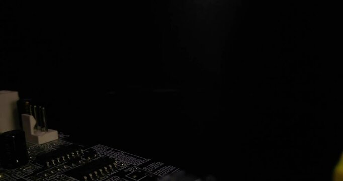 Upgrade memory DDR RAM DIMM and computer repair, slow motion memory installation to motherboard by hand close up on a black background.
