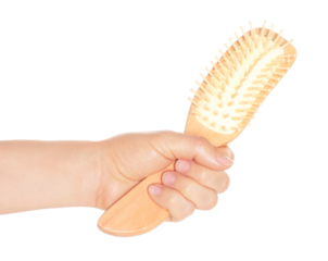 Woman hand holds hairbrush, isolated on transparent background, visage concept