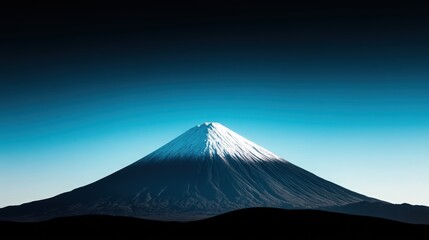 Fototapeta premium A mountain with snow on it is in the background of a blue sky