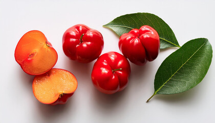 Obraz premium flat lay of acerola cherry with reduce in 1/2 and leaves on white heritage