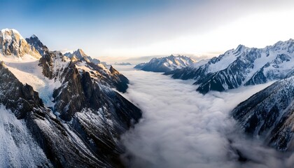 Obraz premium Majestic Snow Capped Mountains Above Cloudscape Panorama