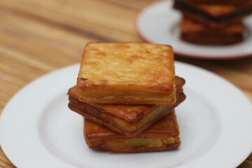 Golden Brown Crispy Crackers Stacked on White Plate