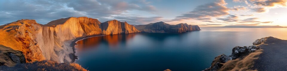 Obraz premium Panoramic view of Lake Srvagsvatn perched dramatically above the ocean, with vibrant cliffs glowing under golden sunlight, in 4K resolution