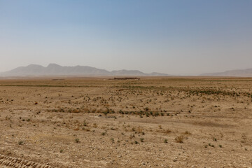 Arid landscape in Kunduz, Afghanistan features distant mountains and sparse vegetation