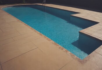 Fototapeta premium A swimming pool that is beautifully surrounded by lawn chairs and trees