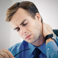 Obraz premium Portrait image - frustrated, exhausted or tired business man in blue shirt, touching neck, at office workplace. Square.