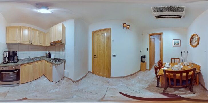A full 360 by 180 degree seamless spherical panorama captures the interior of a modern kitchen in a light color style, presented in equirectangular equidistant projection. This makes it suitable for