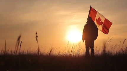 Fototapeten Silhouette of a Person Holding a Canadian Flag at Sunset in a Field : Generative AI © Generative AI