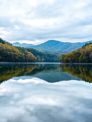Serene Mountain Lake Scene with Autumn Forest Reflections Under Cloudy Sky : Generative AI