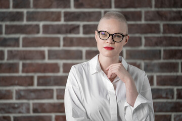 Portrait of a beautiful young caucasian woman with shaved head. Female cancer survivor. Smiling...