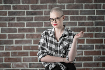 Portrait of a beautiful young caucasian woman with shaved head. Female cancer survivor. Smiling...