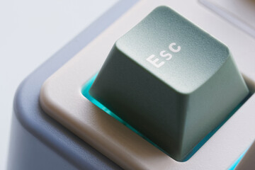 Close-up view of an escape key on a modern computer keyboard during a typical workday at home....