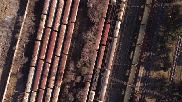 Cinematic view of a train yard for industrial logistics in Tbilisi, Georgia. Rustic trains and freight shipping. 