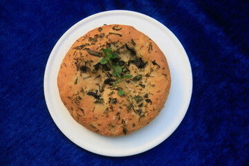 Handmade bread with herbs on a plate