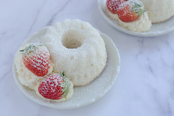 angel food cake light and fluffy sponge cake made with egg whites served with whipped cream and strawberry.