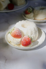 angel food cake light and fluffy sponge cake made with egg whites served with whipped cream and strawberry.