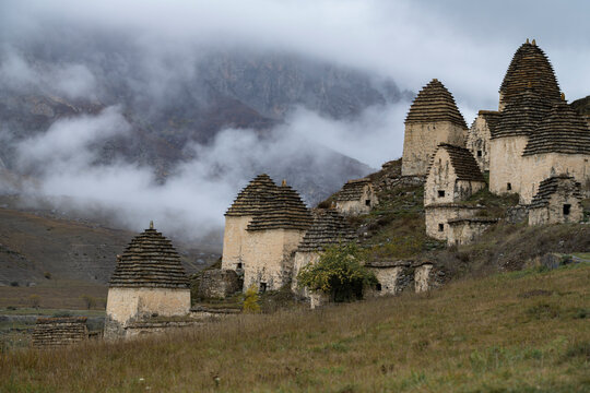 View of the ancient crypts of the City of the Dead (Dargavs) on a foggy October day. North Ossetia - Alania. Russian Federation