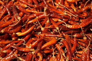 A heap of dry red chili pepper is displayed in a spice market, Dried spicy red chilies are on sale, Showcase of spicy red chili in a spice shop in Asia for the spice trade