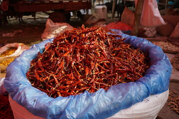 A heap of dry red chili pepper is displayed in a spice market, Dried spicy red chilies are on sale,...