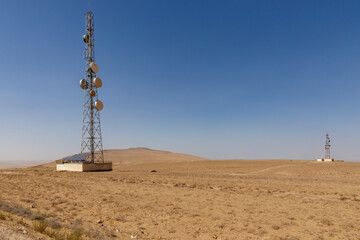 Communication towers in the arid landscape of Kunduz Province Afghanistan during clear weather