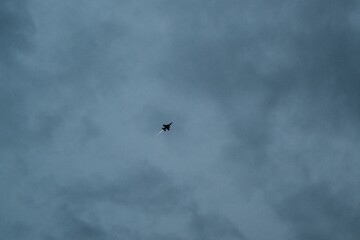 Jet Silhouetted Against Cloudy Sky