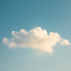 Single cumulus cloud in a clear blue sky.