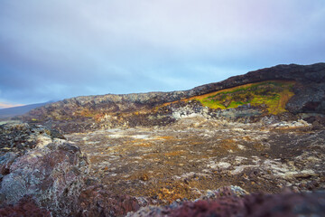 Leirhnjúkur Volcano's colorful geothermal area with lava fields, sulfur deposits, and vibrant moss...