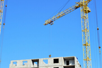 Panorama of construction. Tower crane builds a high-rise building