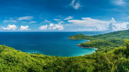 Naklejka premium Lush Green Tropical Coastline Meets Azure Ocean Under Blue Sky