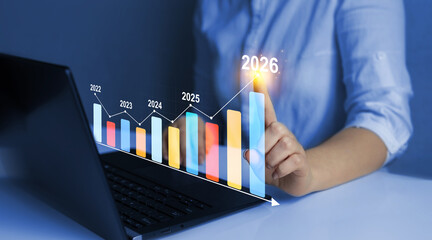 Businessman draws increase arrow graph corporate future growth year 2022 to 2026. Planning,opportunity, challenge and business strategy. New Goals, Plans and Visions for Next Year 2026.	

