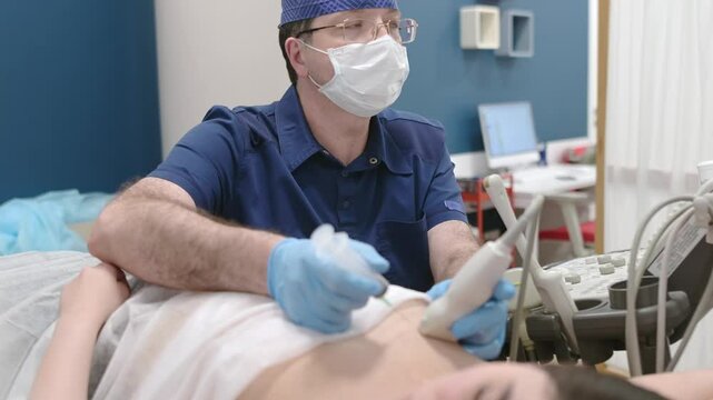 Mammalogist doctor examines a woman breasts and lymph nodes during appointment. Skillful oncologist puncture of mammary glands of young patient under review ultrasound for diagnosis of breast cancer.
