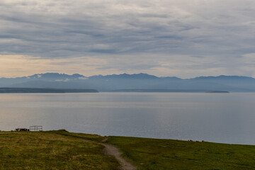 Distant mountains are seen across the water from Fort Ebey State Park, Washington State, USA.