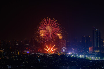 Beautiful fireworks over Chao Praya river with urban city building in Bangkok, Thailand