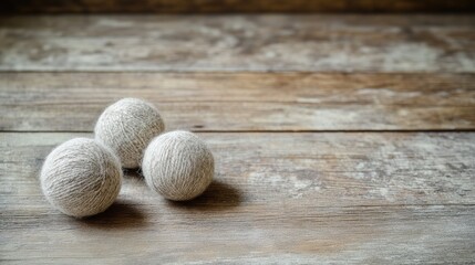 Natural wool balls on rustic wooden table creating a cozy and inviting atmosphere for crafting and interior design themes