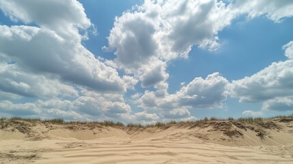 Patterns of Sand Dunes with Dynamic Cloudy Sky Capturing Nature's Textures and Shapes in a Serene Landscape Scene