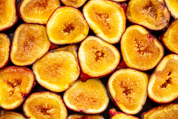 Figs close-up. Heap of figs, whole fruits and cut in half. Sweet exotic fruit for dessert, healthy food.