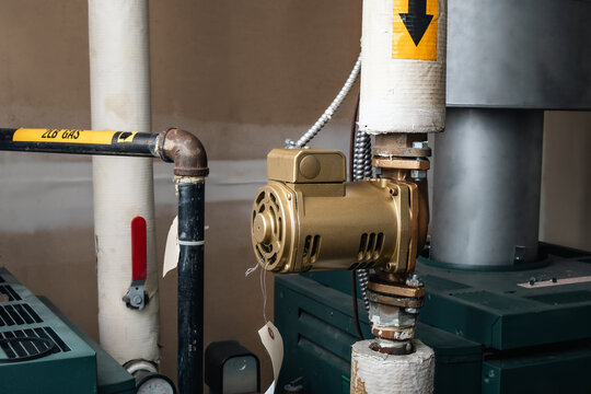 Booster pump or tank booster for hot water tank. Water heater booster is us to mix cold and hot water. Plumbing or hot water heating system for commercial, residential or strata. Selective focus.