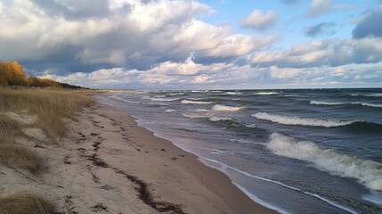 Serene Baltic Beach in Autumn with Rolling Waves and Dramatic Cloudy Skies over Desolate Dunes on a Tranquil Day