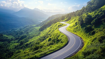 Fototapeta premium Aerial view of scenic winding mountain roads surrounded by lush greenery ideal for automotive advertising and promotional content