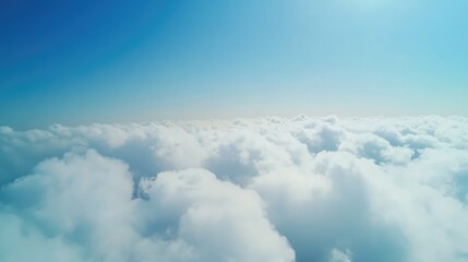 Aerial perspective of bright blue sky filled with soft fluffy clouds ideal for promotional or inspirational text use
